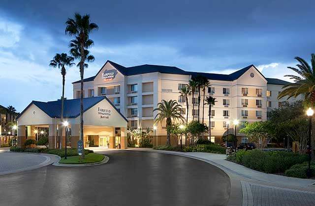 front exterior of hotel building in twilight with entrance at fairfield inn and suites orlando lake buena vista