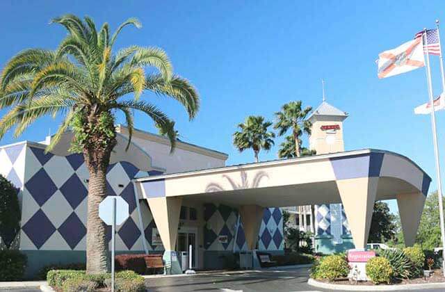 front exterior of hotel with blue and white checkerboard at clarion suites maingate