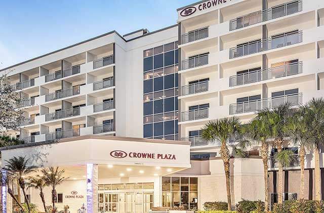 front exterior of upscale hotel with balconies and palm trees at crowne plaza orlando lake buena vista