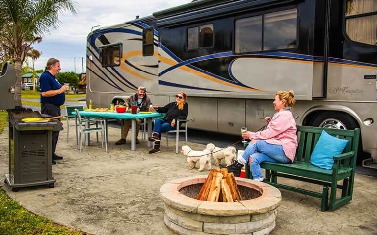 group on patio beside rv at orlando kissimmee koa holiday