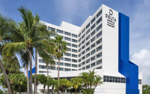 high rise hotel exterior with blue accent at delta hotels by marriott west palm beach