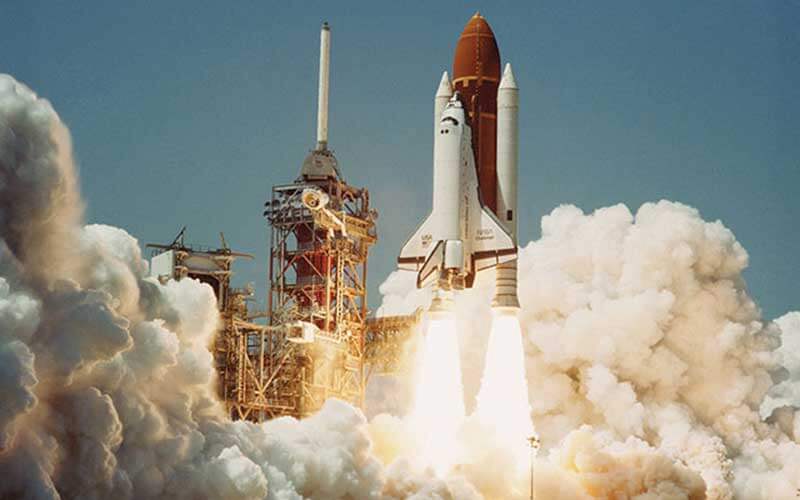 August 30, 1984 - Kennedy Space Center’s first shuttle launch puffs of steam behind a rocket launch with jets coming out of the rocket ship