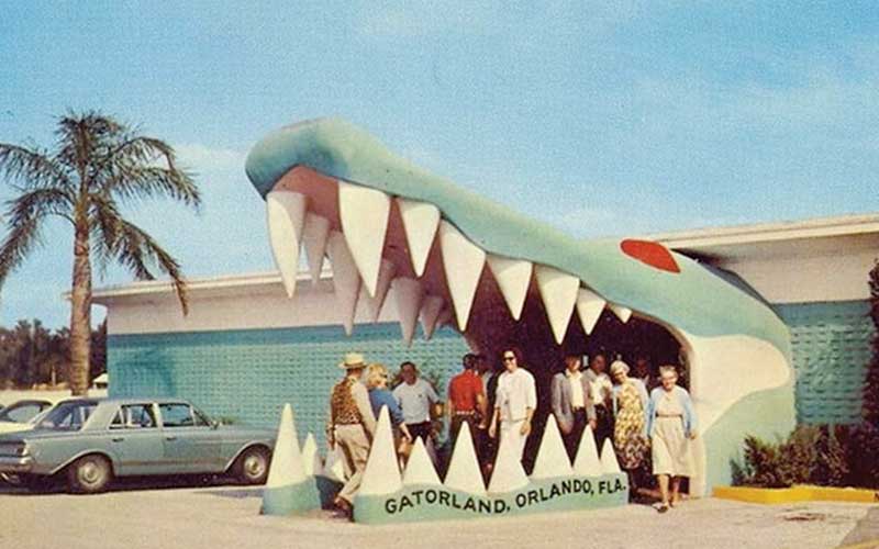 people stand under giant alligator mouth entrance to gatorland orlando the alligator capital of the world in 1949