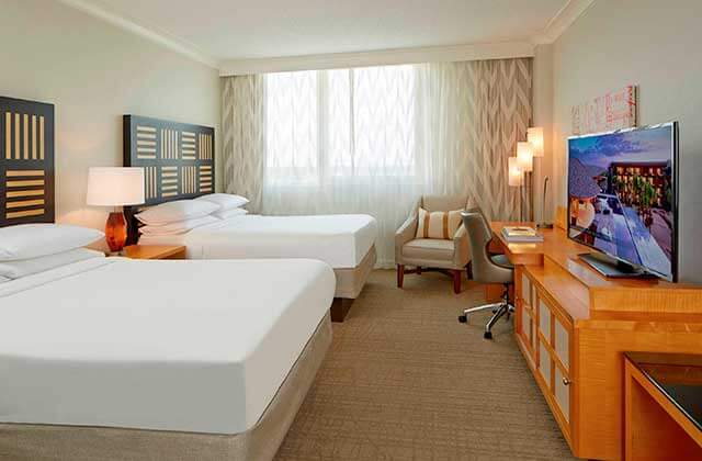 hotel room with two large beds and brown and orange accents at renaissance orlando airport hotel