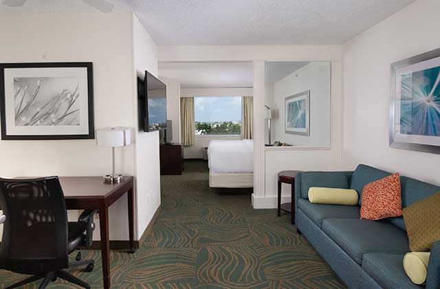 hotel room with view large bed sofa and desk at springhill suites fort lauderdale airport and cruise port