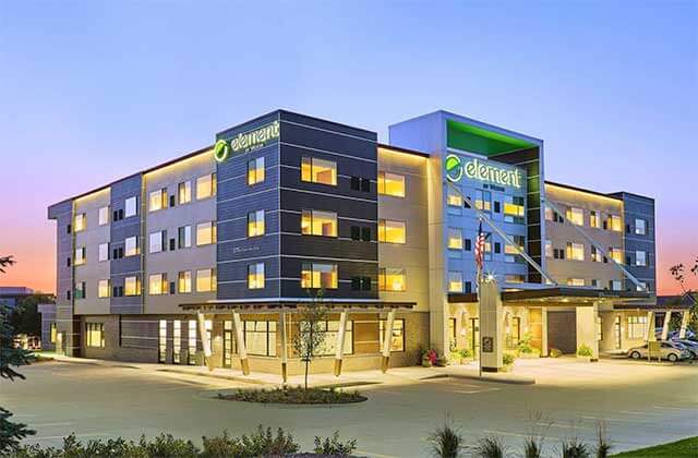 lighted front exterior of hotel building at twilight at element orlando international drive