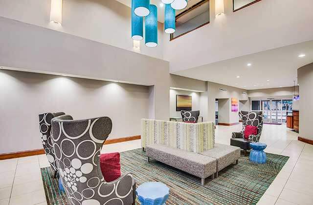 lobby and lounge area with trendy seating at residence inn by marriott orlando airport