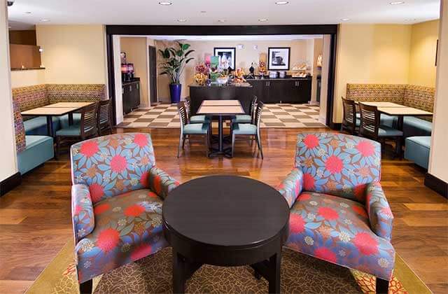 lobby with floral pattern and dining seating at hampton inn suites sarasota lakewood ranch
