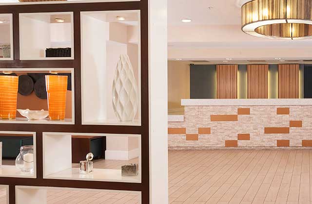 lobby with front desk and shelves with glass sculptures at residence inn by marriott orlando convention center