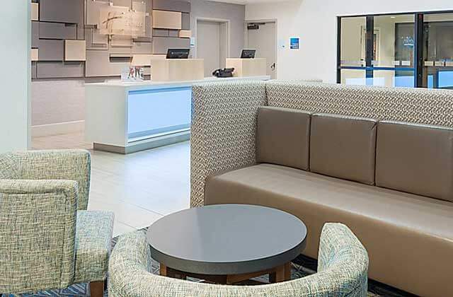 lobby with seating and front desk at holiday inn express and suites nearest universal orlando