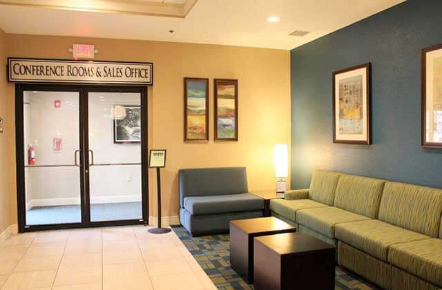 lounge area with sofas and conference center entrance at rosen inn international