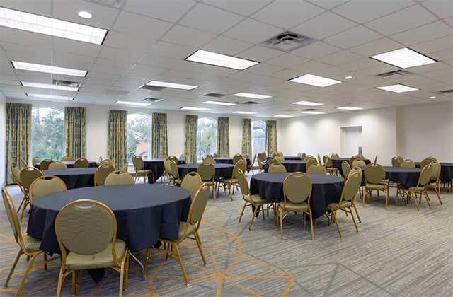 meeting event space in room with trendy carpets blue tables and green chairs at wyndham garden tallahassee capitol