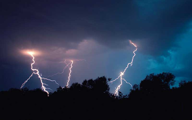 photo of a nighttime skyline with lightning 