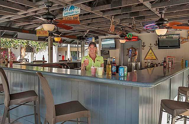 outdoor covered bar area with lady serving drinks at staybridge suites orlando royale parc suites