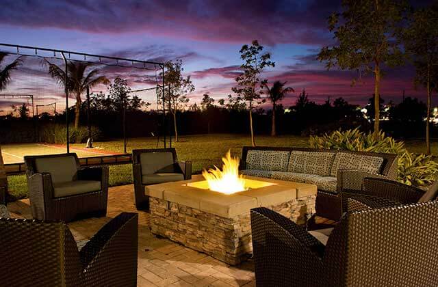 patio area at night with fire pit and wicker seating at residence inn fort myers sanibel