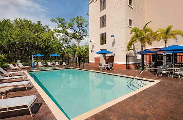 pool area with blue umbrellas at fairfield inn and suites clearwater