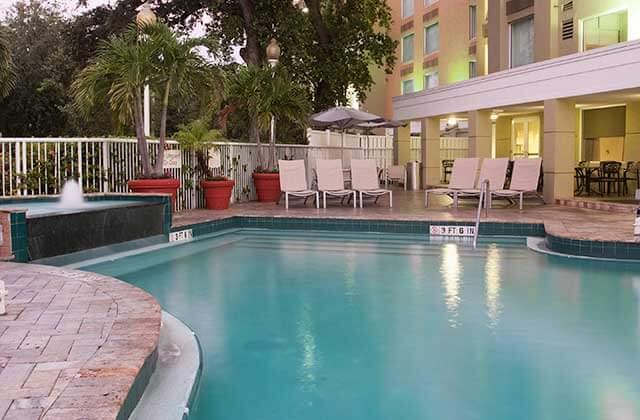 pool area with fountain feature and red planters at springhill suites fort lauderdale airport and cruise port