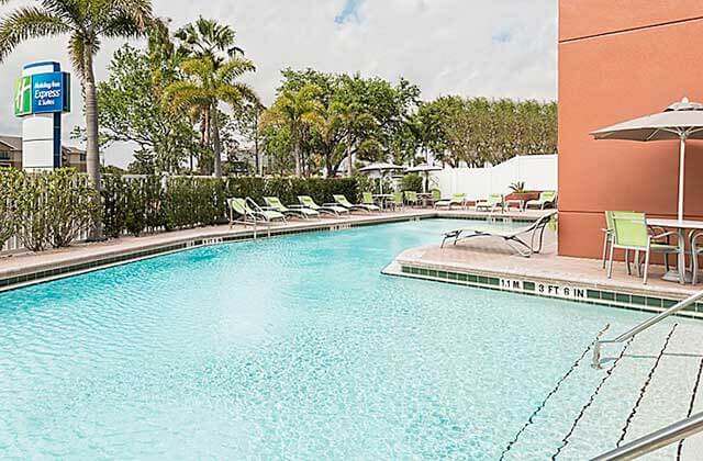 pool area with green lounge chairs at holiday inn express and suites nearest universal orlando