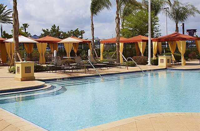 pool area with orange and yellow cabanas at hilton garden inn orlando international drive north