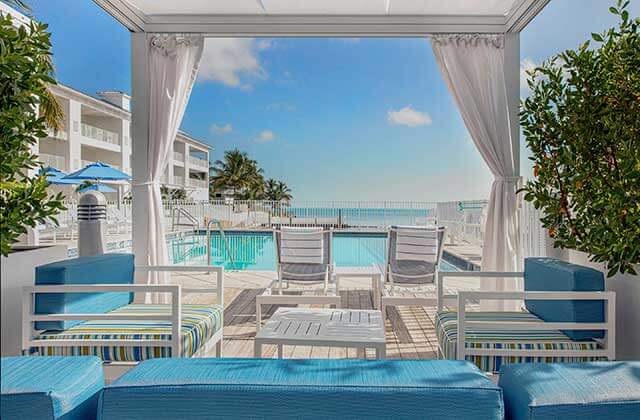 pool area with white cabanas and blue umbrellas at courtyard marathon florida keys