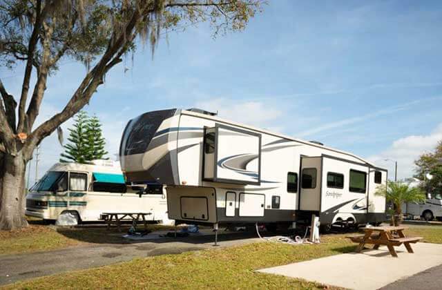 recreational camper trailer with picnic table and hook-ups at sun outdoors orlando championsgate rv resort