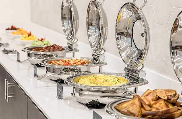 row of breakfast buffet items in stainless steel trays at crowne plaza orlando lake buena vista