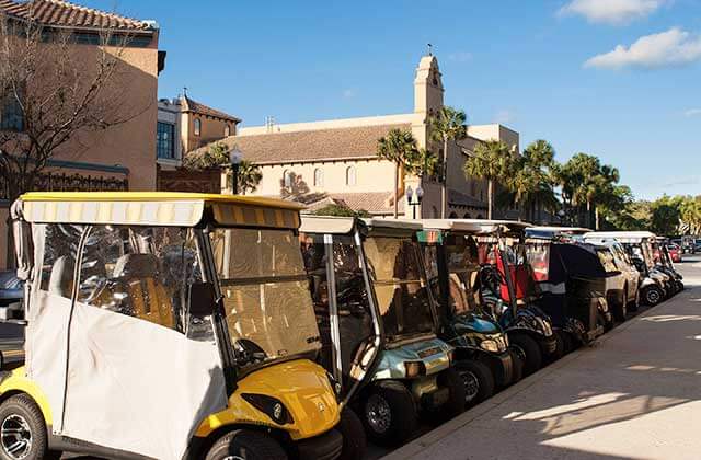 row of covered golf carts at towneplace suites the villages