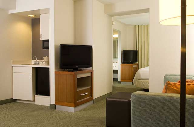 suite room with separate areas bedroom and two tvs at springhill suites orlando convention center international drive area