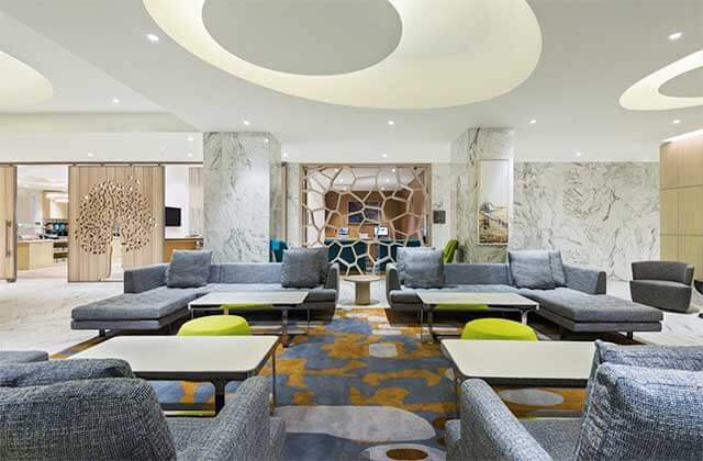 trendy lobby area with wood elements and blue and green decor at homewood suites by hilton sarasota lakewood ranch