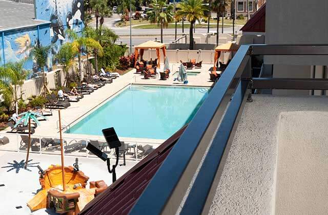 view from balcony of pool area with orange cabanas at delta hotels orlando lake buena vista