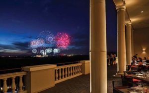 night with fireworks display over disney on the horizon view from balcony rooftop of capa steakhouse at four seasons lake buena vista