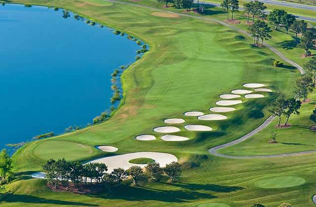 aerial view of golf course with fairway along water and series of bunkers at falcons fire golf club kissimmee