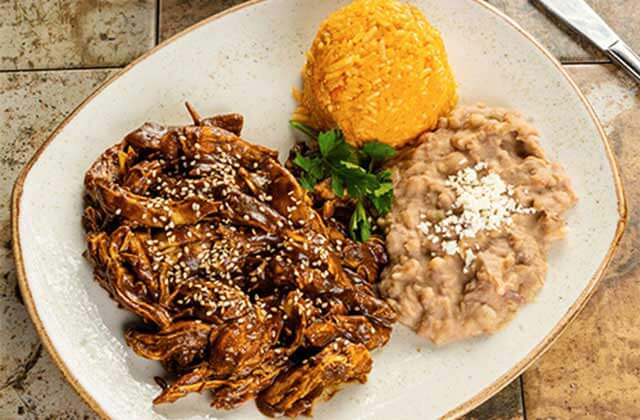 chicken entree with chocolate and sesame seed mole rice and beans at senor frogs orlando