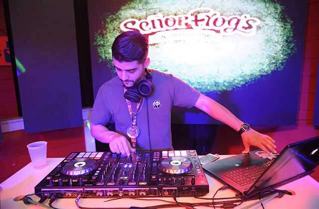 deejay with laptop and turntable system and projected lighting at senor frogs orlando