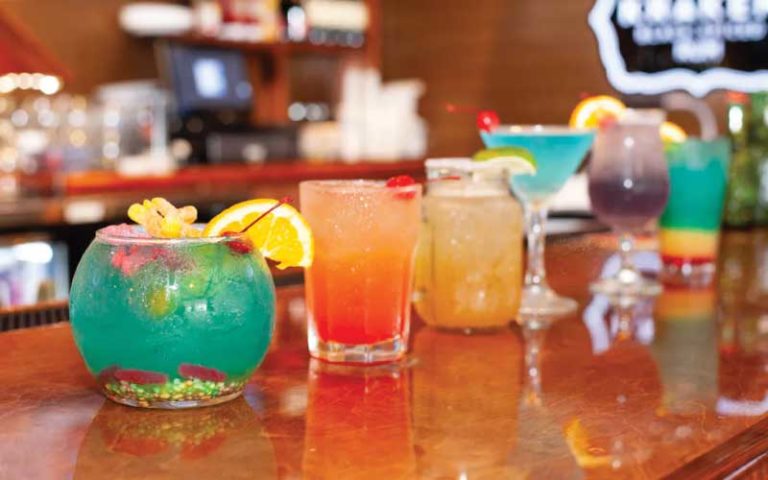 row of cocktails along bar top with bright colors at the juicy crab international drive orlando