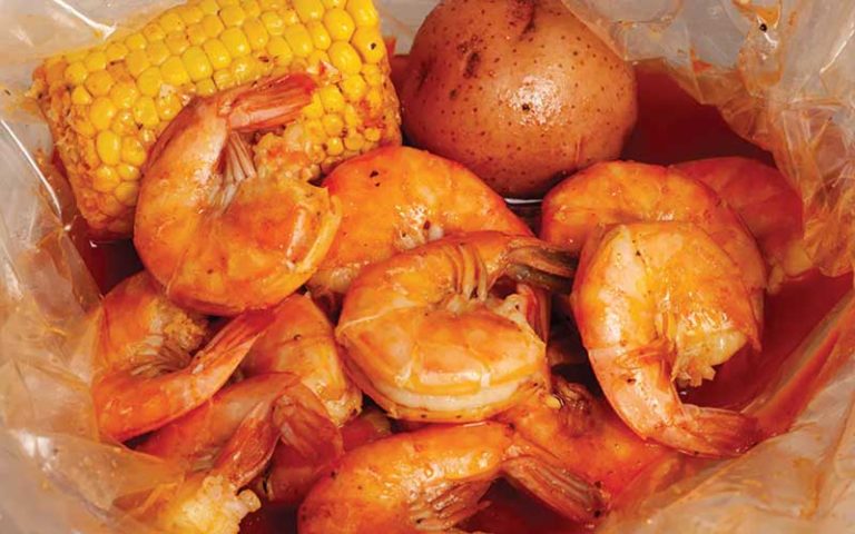 shrimp corn cob and potato seafood boil with red seasoning sauce at the juicy crab international drive orlando