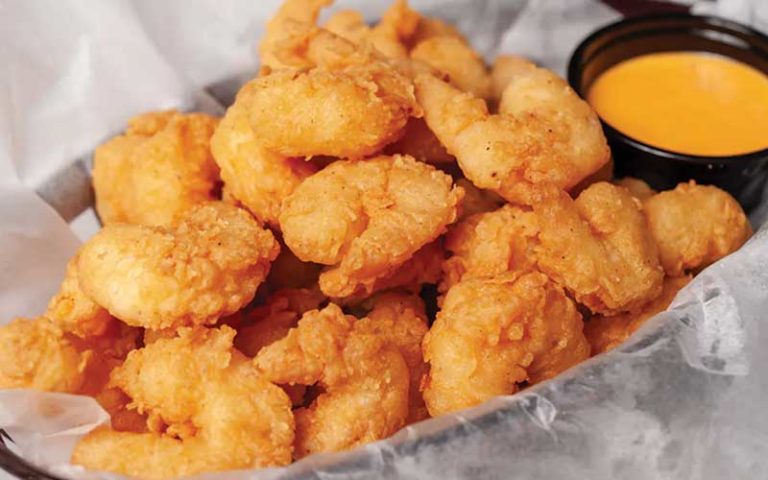 tray of golden breaded fried shrimp with orange sauce at the juicy crab international drive orlando