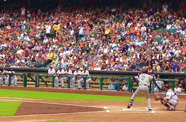 professional baseball player at bat over plate with catcher and crowds for florida sports page
