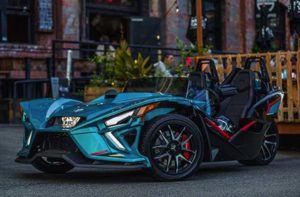 blue slingshot vehicle parked by patio at florida slingshots