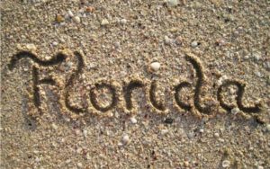 scripty word florida drawn in sand with shells at beach for fun in the winter sun blog