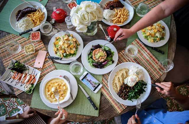 table with diners eating various entrees salads and soups at villaggio restaurant kissimmee