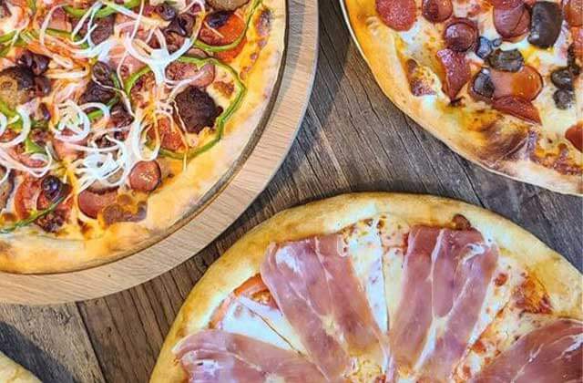 three unique gourmet pizzas with charcuterie meats at villaggio restaurant kissimmee