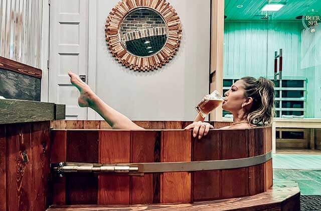 beer spa orlando girl drinking stein of beer soaking in tub