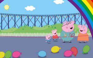 cartoon graphic of peppa pig characters on playground with rainbow and opening ribbon for peppa pig theme park at legoland florida resort