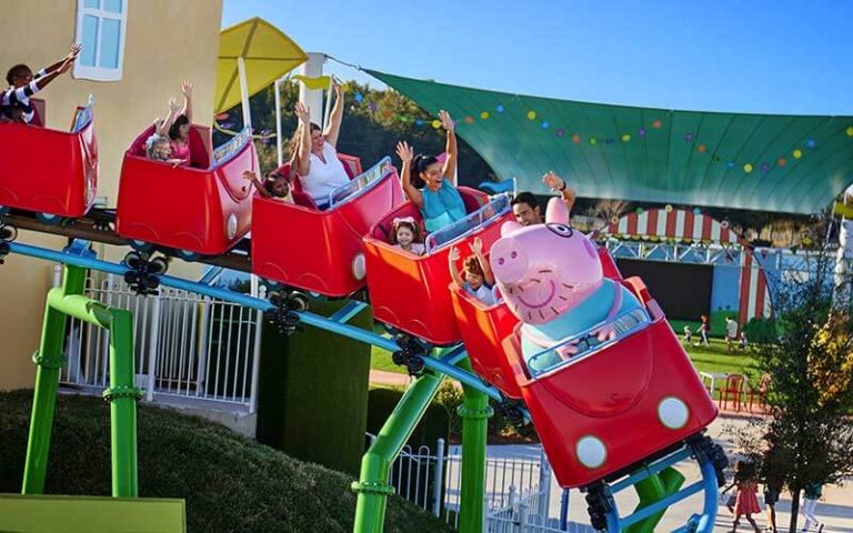 families riding daddy pig roller coaster at peppa pig theme park legoland florida
