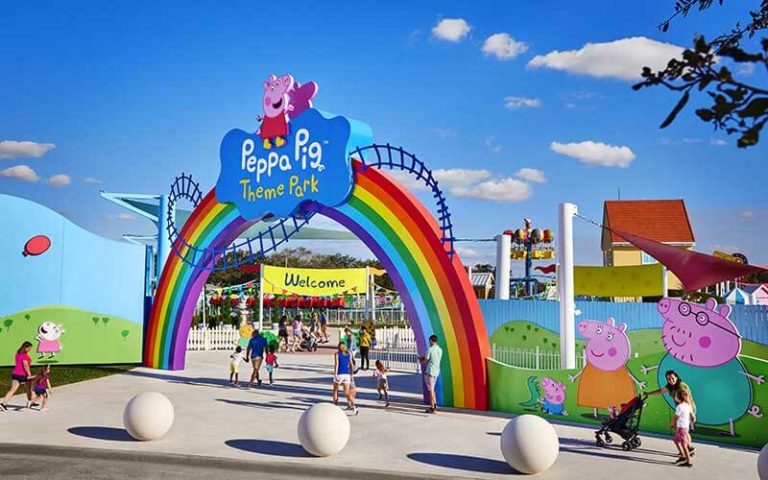gate with welcome sign entrance with families at peppa pig theme park legoland florida