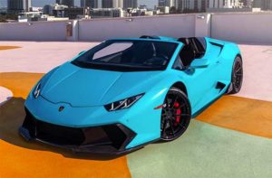 cyan blue lamborghini supercar on rooftop garage downtown at blast supercar driving experience