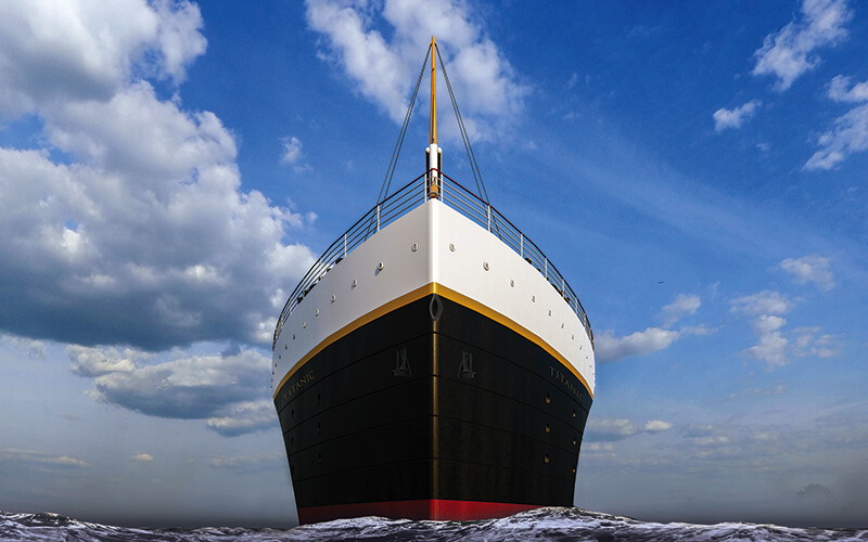 front facing hero shot of bow of titanic ship with waves and blue cloudy sky at titanic the artifact exhibition orlando