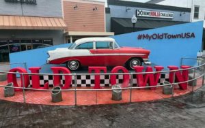 red and white classic car mounted to sign for old town entertainment district kissimmee