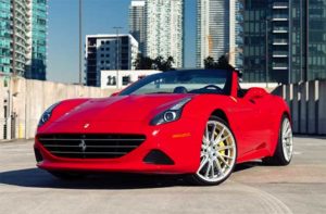 red ferrari supercar convertible rooftop with miami skyline at blast supercar driving experience